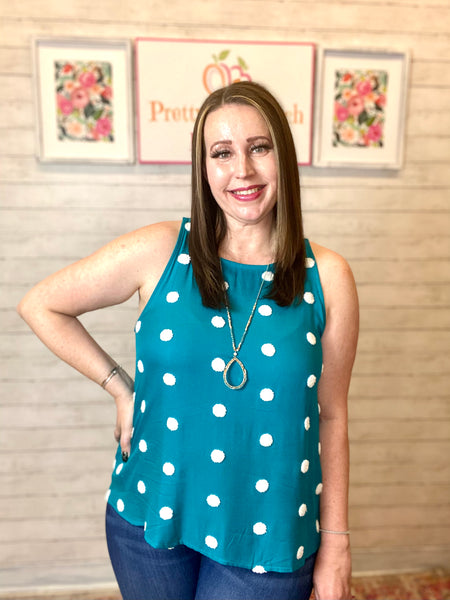 Model wearing our Teal Polka Dot Tank Top. It's a tank that's teal with ivory polka dots all over. The tank is a scoop neckline. 