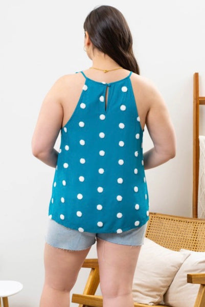 Model wearing our Teal Polka Dot Tank Top. It's a tank that's teal with ivory polka dots all over. The tank is a scoop neckline. The back has a keyhole effect with a small button tying them together.