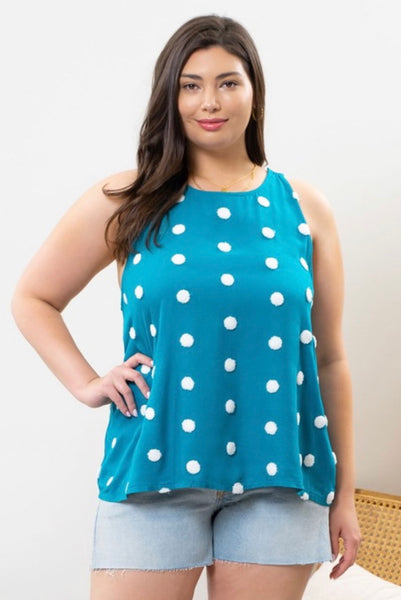 Model wearing our Teal Polka Dot Tank Top. It's a tank that's teal with ivory polka dots all over. The tank is a scoop neckline.